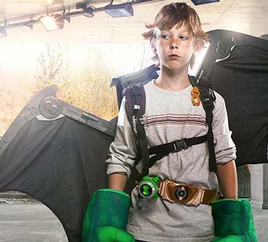 A boy with green gloves and a bat.