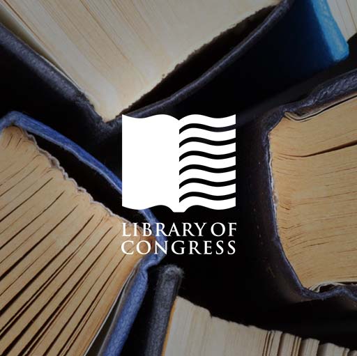 A close up of an open book with the library of congress logo.