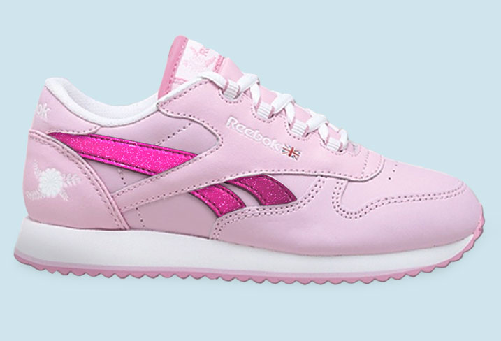 A pink reebok sneaker with white and purple accents.